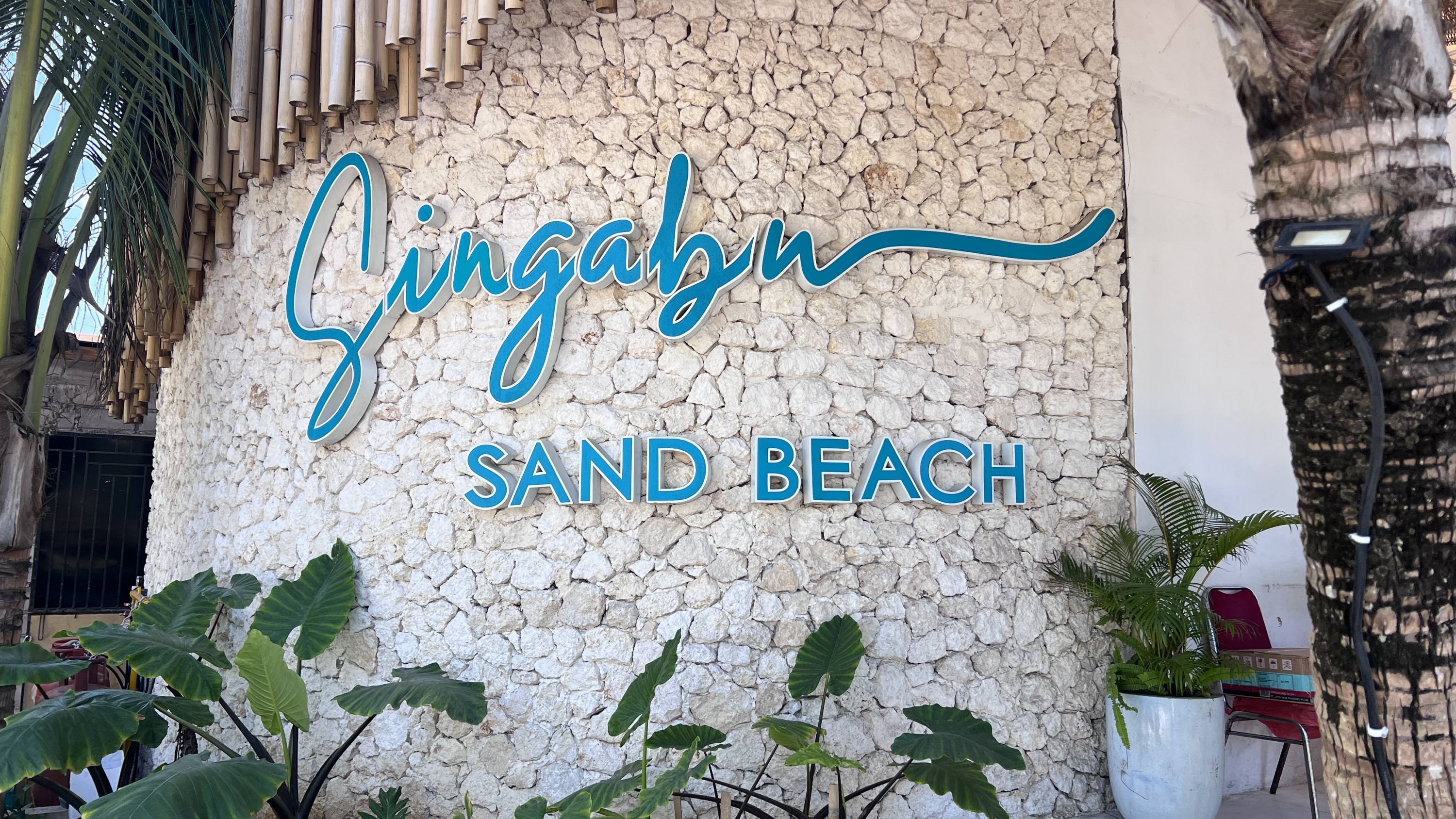 Singabu Beach Club sign on the road